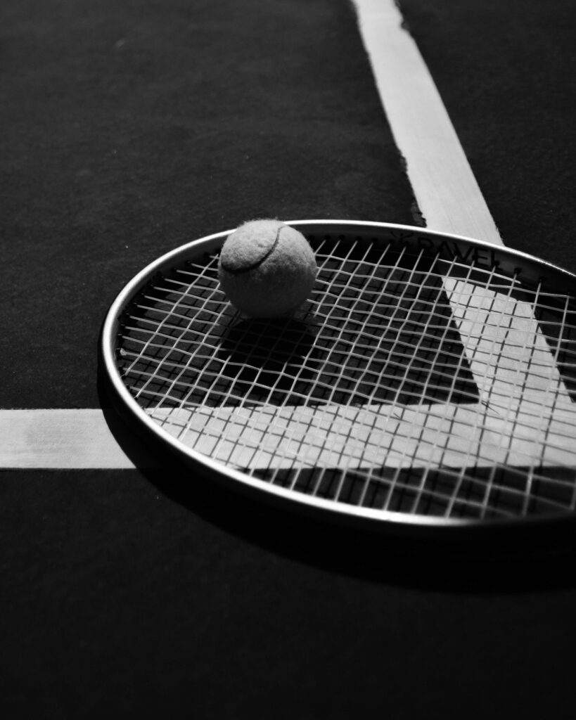 A close-up of a tennis racket and ball on a court in İzmir, Türkiye.